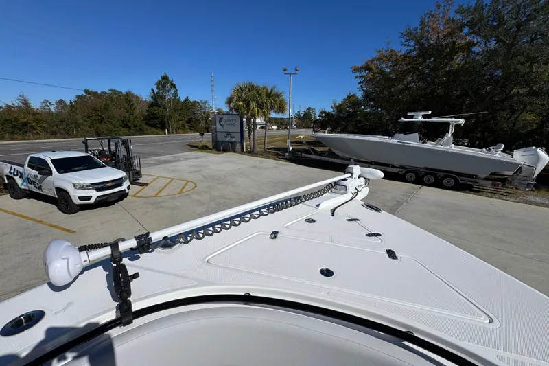  Yacht Photos Pics 2023 Fountain 34 Tournament Edition boat on trailer, parked near a white truck.