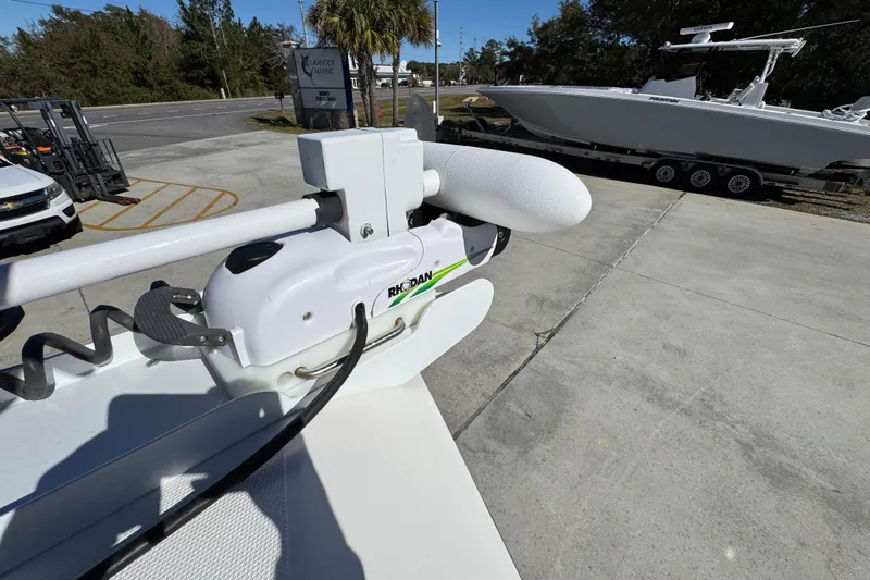  Yacht Photos Pics 2023 Fountain 34 Tournament Edition boat with Rhodan trolling motor in a marina setting.