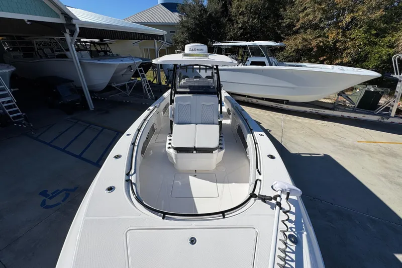  Yacht Photos Pics 2023 Fountain 34 Tournament Edition boat in a marina, showcasing sleek design and spacious deck.