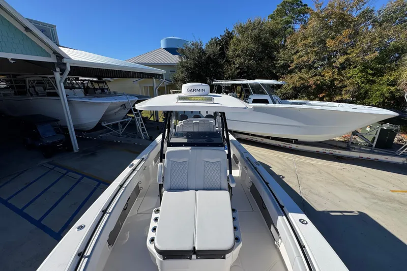  Yacht Photos Pics 2023 Fountain 34 Tournament Edition boat in marina, surrounded by other vessels.