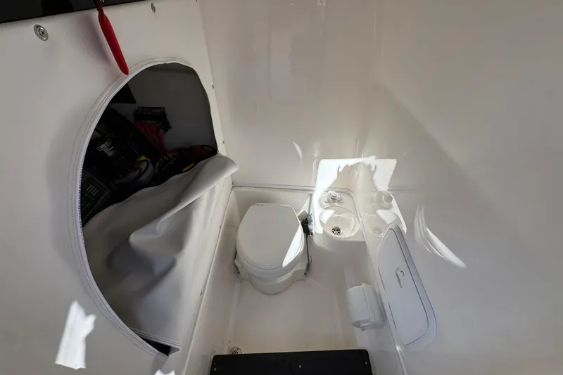  Yacht Photos Pics Interior of 2023 Fountain 34 Tournament Edition boat with compact toilet and storage area.