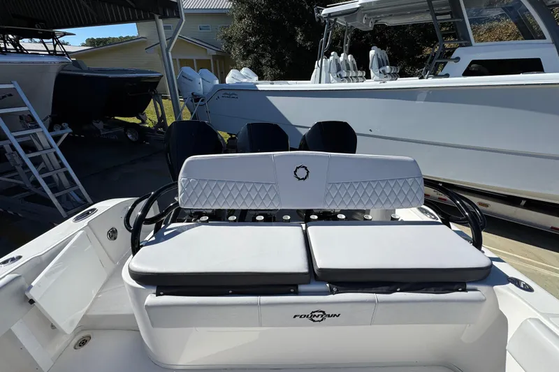  Yacht Photos Pics 2023 Fountain 34 Tournament Edition boat interior with cushioned seating and sleek design.