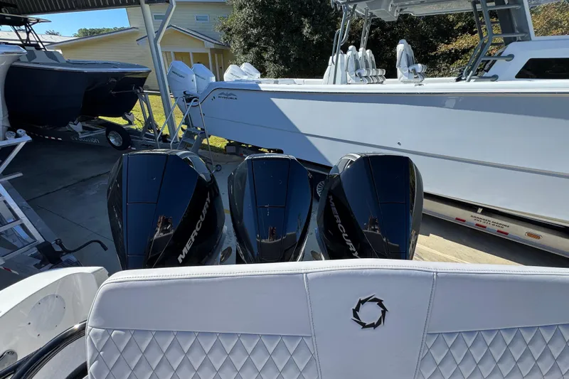  Yacht Photos Pics 2023 Fountain 34 Tournament Edition boat with triple Mercury engines in a marina.