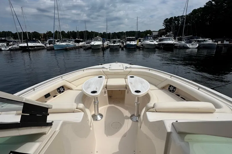  Yacht Photos Pics 2023 Grady-White Freedom 375 boat interior at marina, featuring seating and tables.