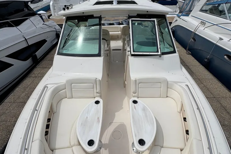  Yacht Photos Pics 2023 Grady-White Freedom 375 boat interior with seating and table, docked among other boats.