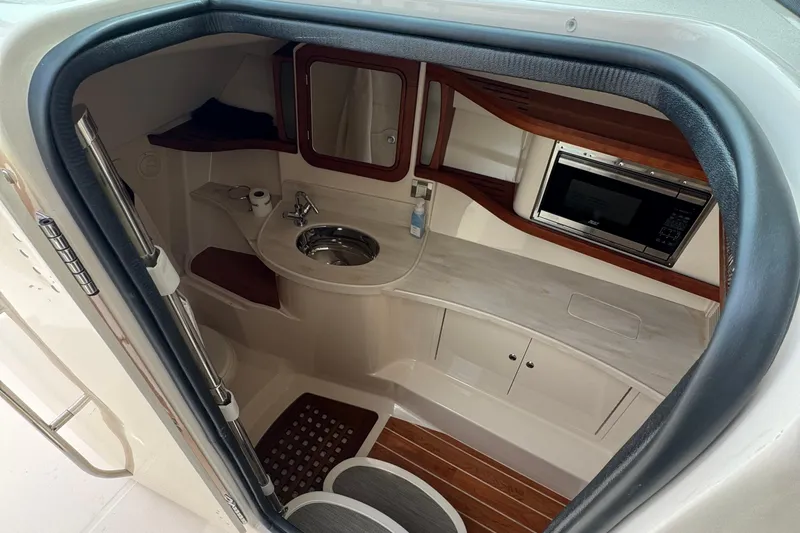  Yacht Photos Pics 2023 Grady-White Freedom 375 cabin interior with sink, mirror, and microwave.