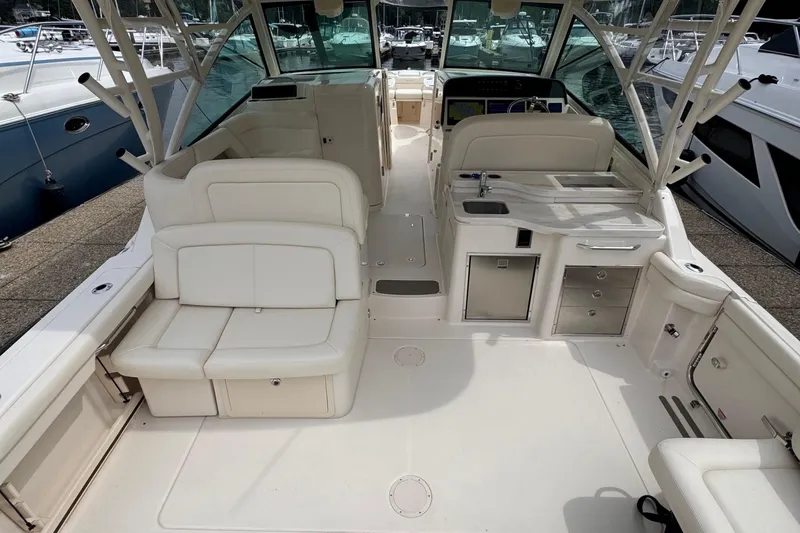  Yacht Photos Pics 2023 Grady-White Freedom 375 boat interior with white seating and kitchenette.