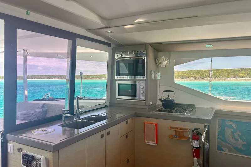 Sabai Sabai Yacht Photos Pics Modern kitchen interior of 2018 Fountaine Pajot Lucia 40 catamaran with ocean view.