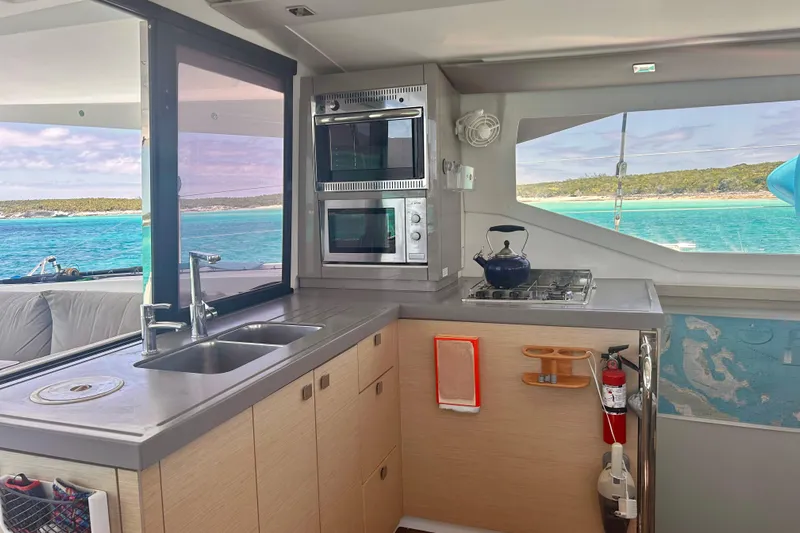 Sabai Sabai Yacht Photos Pics Modern kitchen interior of 2018 Fountaine Pajot Lucia 40 catamaran with ocean view.