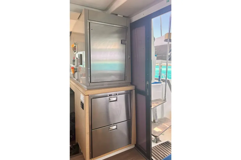 Sabai Sabai Yacht Photos Pics Modern kitchen area on 2018 Fountaine Pajot Lucia 40 catamaran with stainless steel appliances.