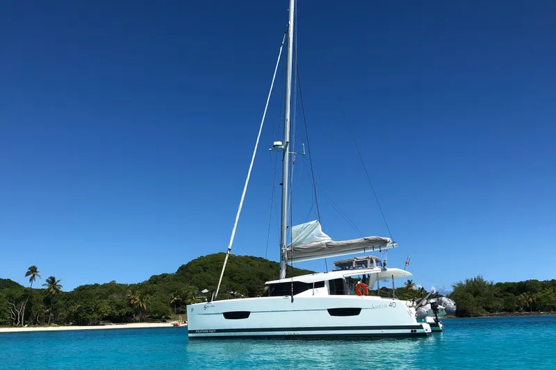 Sabai Sabai Yacht Photos Pics 2018 Fountaine Pajot Lucia 40 catamaran anchored in clear blue tropical waters.