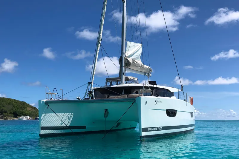 Sabai Sabai Yacht Photos Pics 2018 Fountaine Pajot Lucia 40 catamaran sailing on clear blue waters.