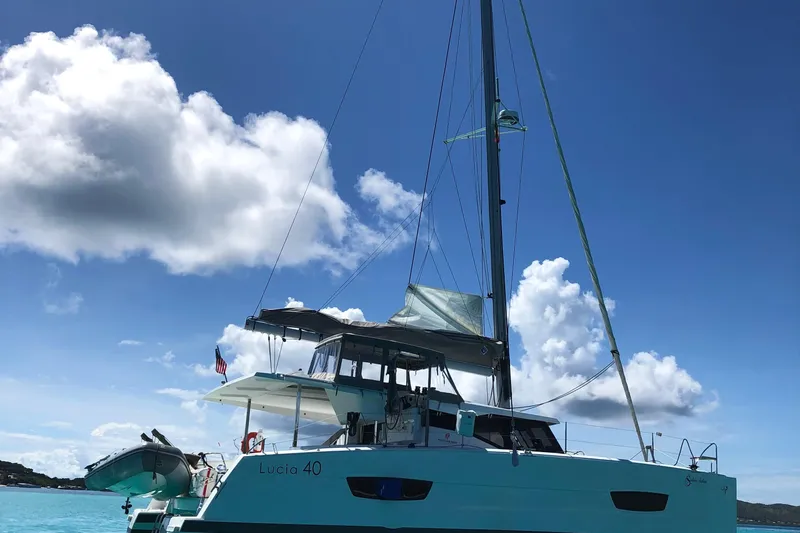 Sabai Sabai Yacht Photos Pics 2018 Fountaine Pajot Lucia 40 catamaran sailing under a clear blue sky.