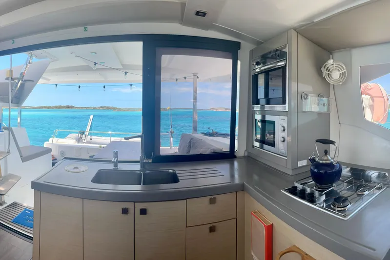 Sabai Sabai Yacht Photos Pics Interior of 2018 Fountaine Pajot Lucia 40 catamaran with ocean view through kitchen window.
