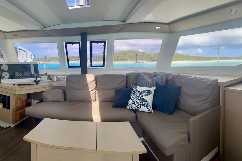Sabai Sabai Yacht Photos Pics Interior of 2018 Fountaine Pajot Lucia 40 catamaran with ocean view through large windows.