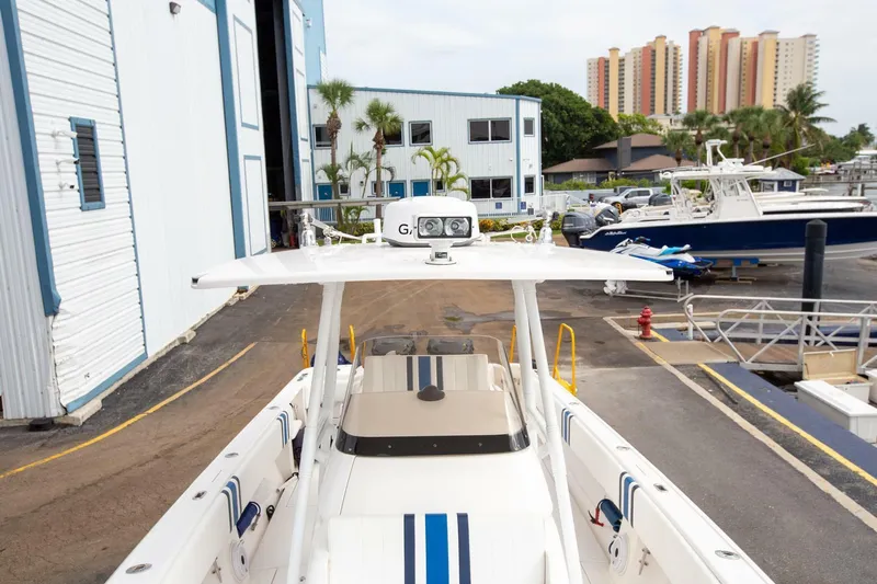  Yacht Photos Pics 2011 Intrepid 32 boat docked at a marina with buildings and palm trees in the background.