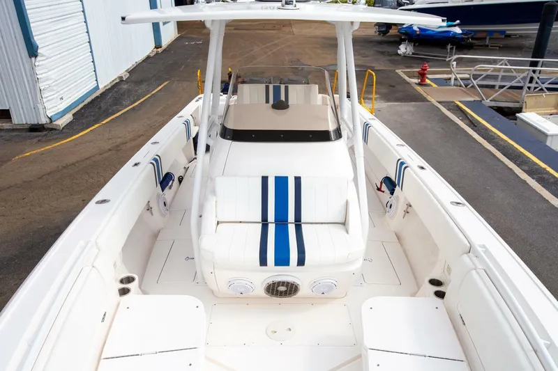  Yacht Photos Pics 2011 Intrepid 32 boat with white and blue seating, docked at a marina.