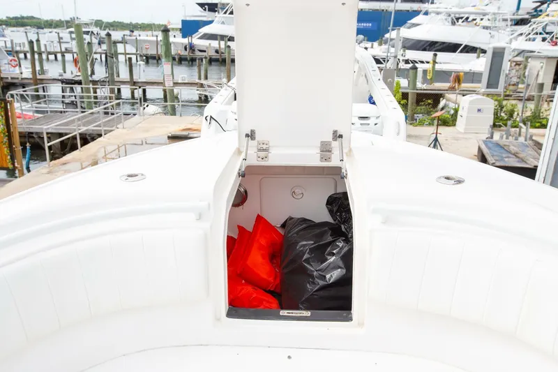  Yacht Photos Pics Open storage compartment on 2011 Intrepid 32 boat with life jackets, docked at marina.
