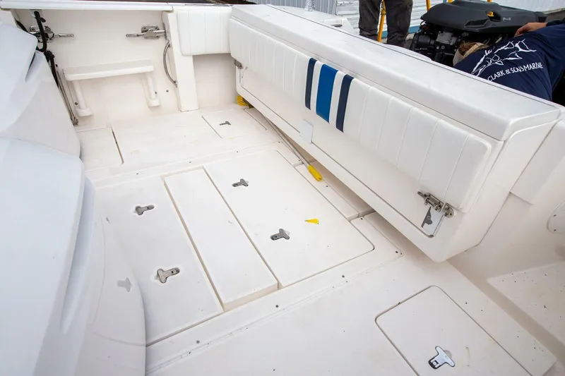  Yacht Photos Pics 2011 Intrepid 32 boat interior with white seating and storage compartments.