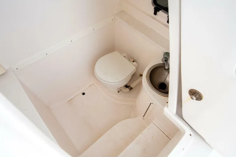  Yacht Photos Pics 2011 Intrepid 32 boat bathroom with toilet and sink, compact and functional design.