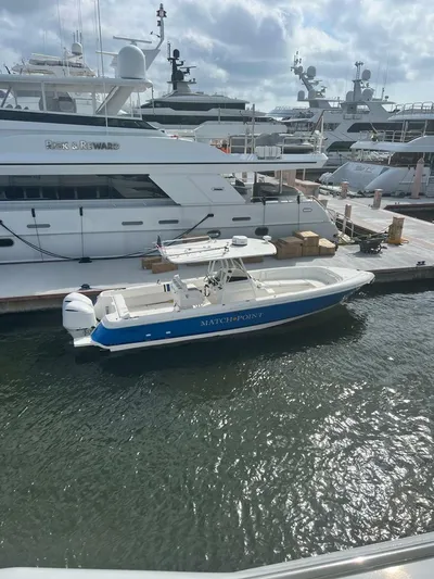  Yacht Photos Pics 2011 Intrepid 32 boat docked at marina, surrounded by larger yachts.