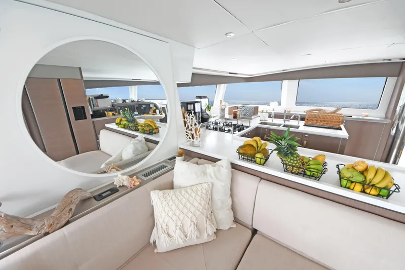 Crystal Dreams Yacht Photos Pics Luxurious Bali 5.4 yacht interior with modern kitchen, fruit baskets, and ocean view, 2022 model.