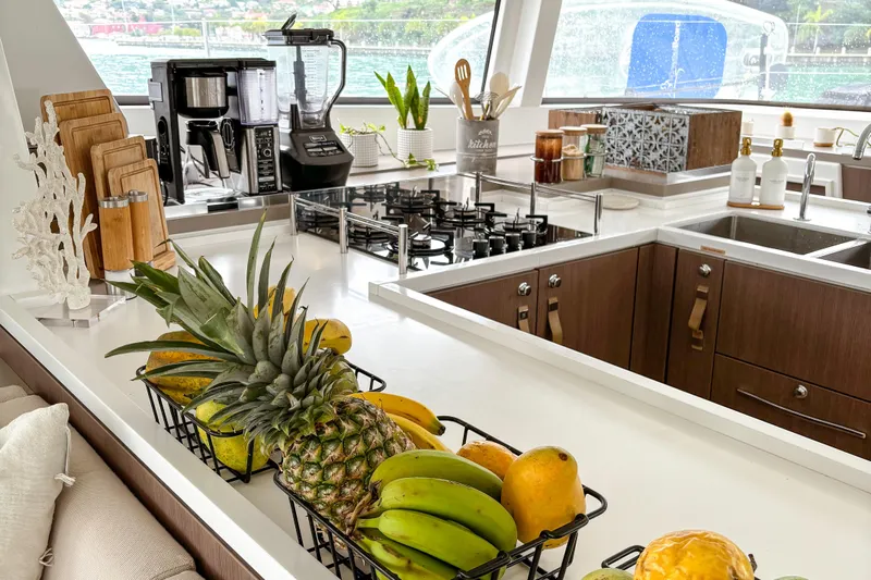 Crystal Dreams Yacht Photos Pics Modern yacht kitchen with fresh fruit, appliances, and ocean view, Bali 5.4 model, 2022.