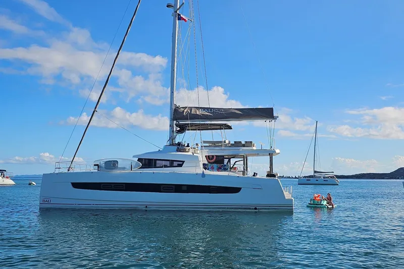 Crystal Dreams Yacht Photos Pics 2022 Bali 5.4 catamaran sailing on calm waters under a clear blue sky.