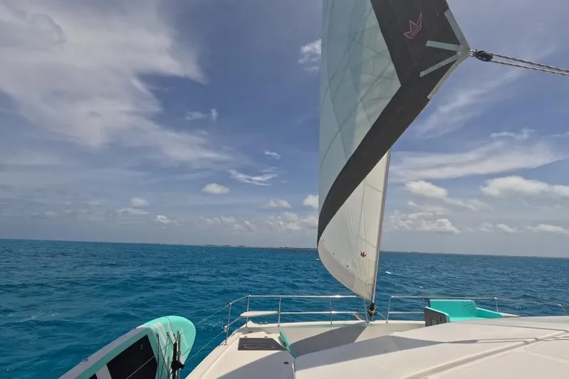 Crystal Dreams Yacht Photos Pics Sailing on a 2022 Bali 5.4 catamaran in clear blue ocean under a sunny sky.