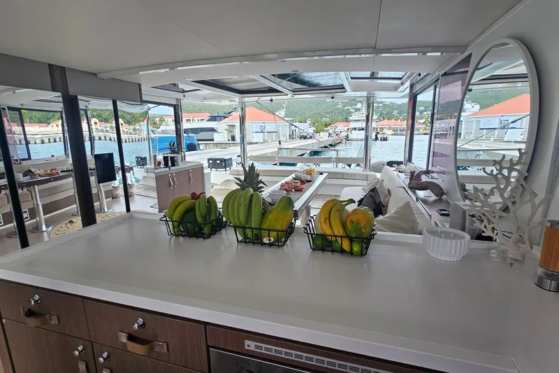 Crystal Dreams Yacht Photos Pics Luxurious Bali 5.4 yacht interior with fruit baskets, modern design, and marina view, 2022 model.