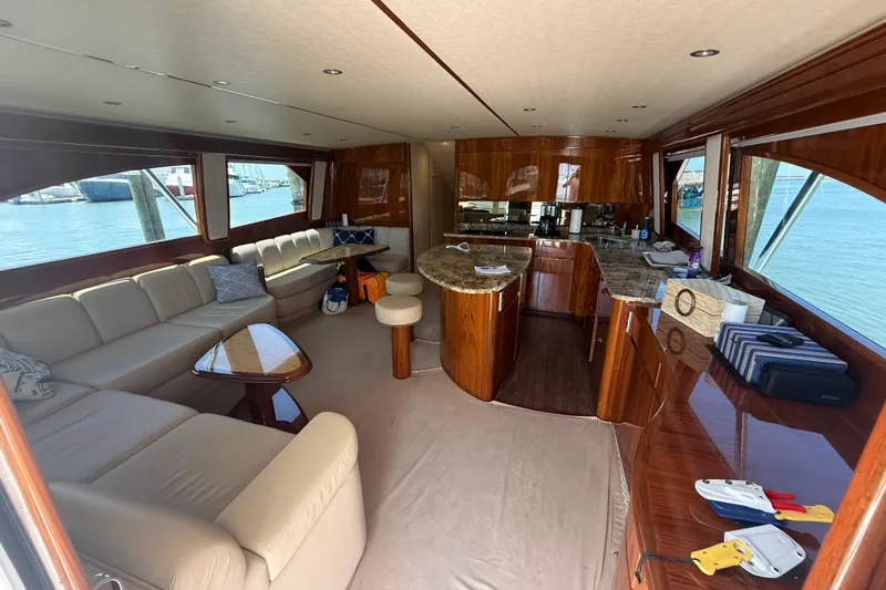 62025 Yacht Photos Pics Luxurious interior of 2016 Viking 62 Convertible yacht with elegant seating and kitchen area.