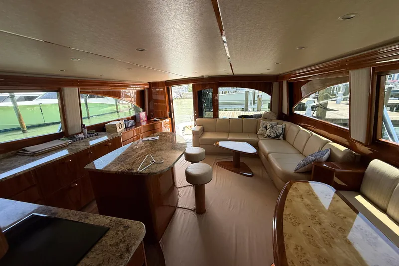 62025 Yacht Photos Pics Luxurious interior of a 2016 Viking 62 Convertible yacht with elegant seating and wooden finishes.