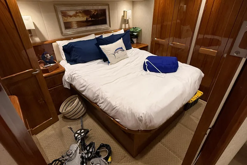 62025 Yacht Photos Pics Luxurious cabin interior of 2016 Viking 62 Convertible yacht with cozy bed and wooden furnishings.