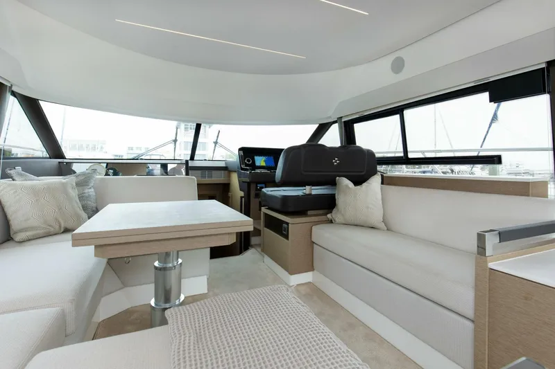 Pass-n-bye Yacht Photos Pics Luxurious interior of 2023 Prestige 460 Flybridge yacht with modern seating and navigation area.