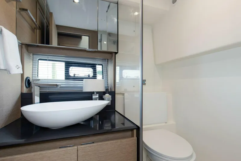 Pass-n-bye Yacht Photos Pics Modern bathroom in 2023 Prestige 460 Flybridge yacht with sleek design and elegant fixtures.