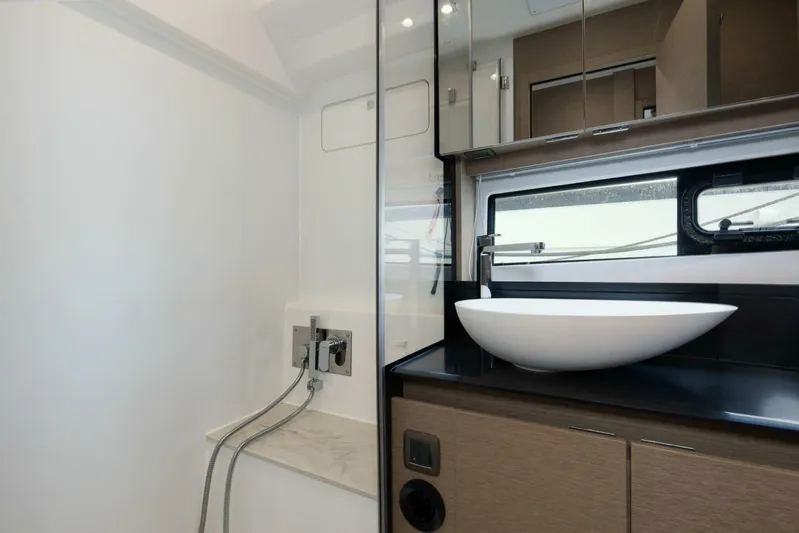 Pass-n-bye Yacht Photos Pics Modern bathroom interior on 2023 Prestige 460 Flybridge yacht, featuring sleek sink and shower.