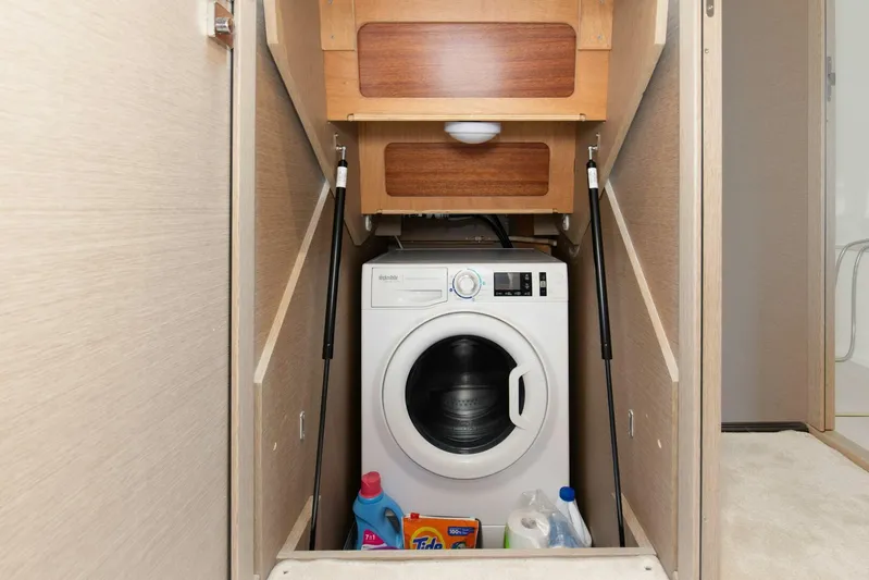 Pass-n-bye Yacht Photos Pics Laundry area with washing machine on 2023 Prestige 460 Flybridge yacht.