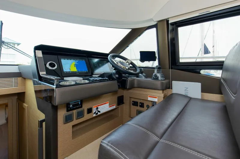 Pass-n-bye Yacht Photos Pics 2023 Prestige 460 Flybridge helm with modern navigation system and leather seating.