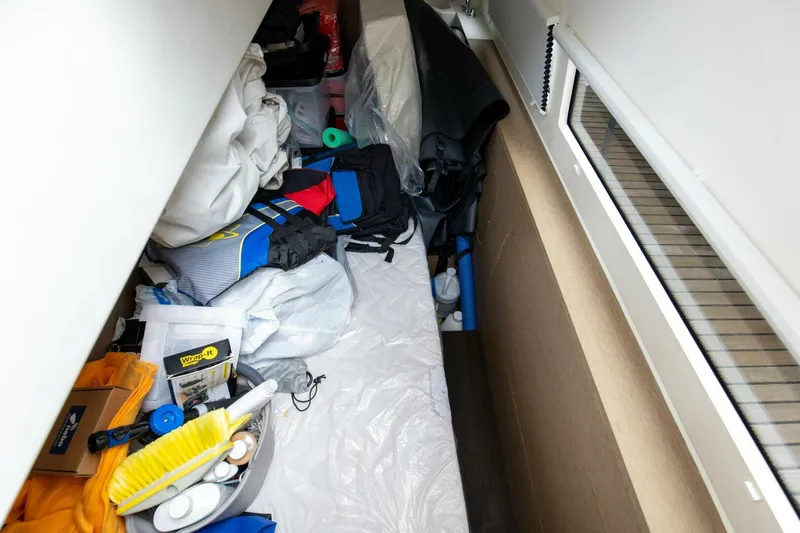 Pass-n-bye Yacht Photos Pics Storage area in a 2023 Prestige 460 Flybridge yacht, filled with various supplies and equipment.