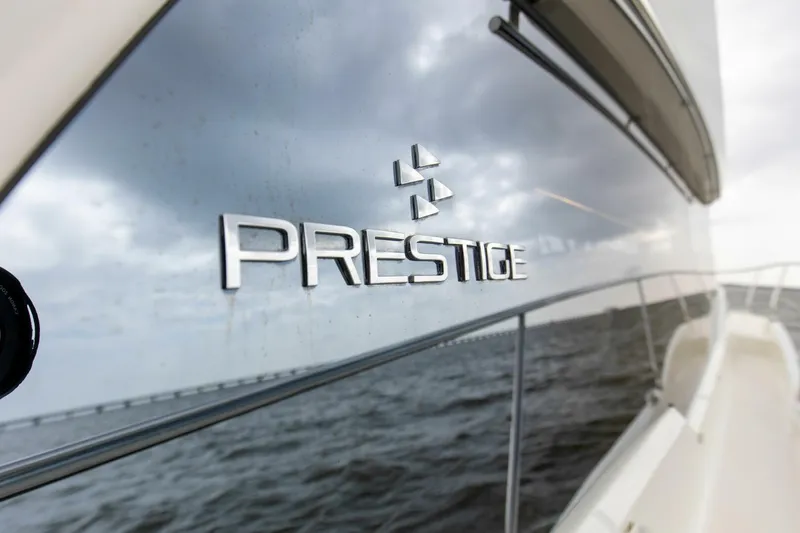 Pass-n-bye Yacht Photos Pics Prestige 460 Flybridge yacht on water, showcasing sleek design and luxury.