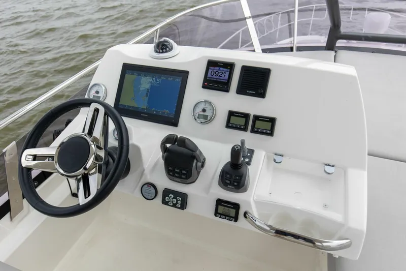 Pass-n-bye Yacht Photos Pics 2023 Prestige 460 Flybridge helm with navigation controls and steering wheel.