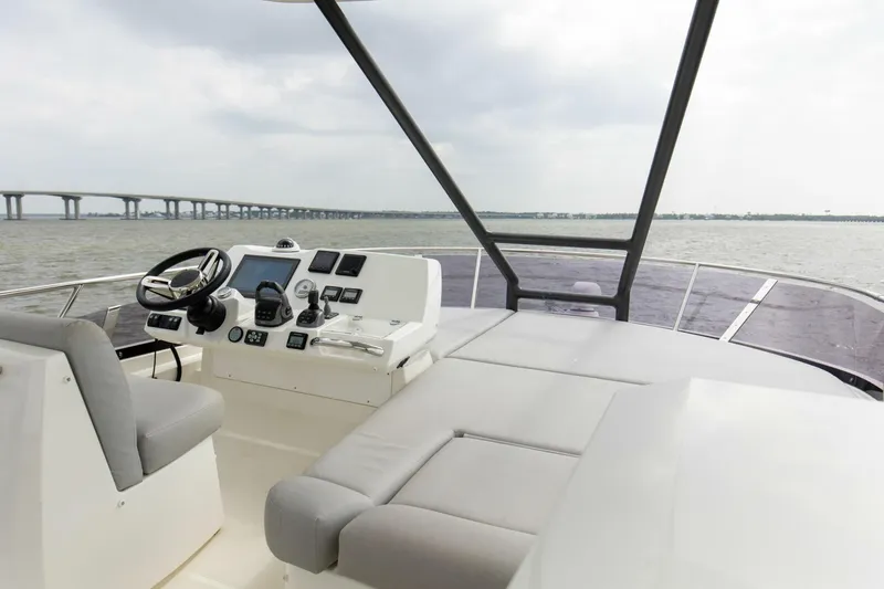 Pass-n-bye Yacht Photos Pics Prestige 460 Flybridge 2023 yacht helm with modern controls and panoramic water view.