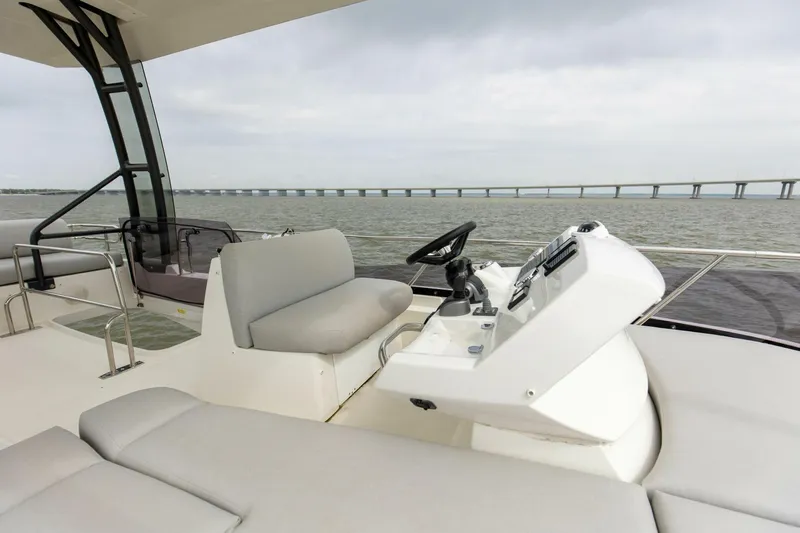 Pass-n-bye Yacht Photos Pics Flybridge view of 2023 Prestige 460 yacht with modern helm and seating.