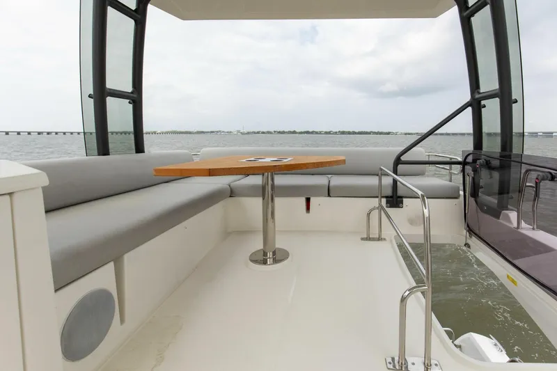 Pass-n-bye Yacht Photos Pics Prestige 460 Flybridge 2023 yacht with spacious seating and table on deck.