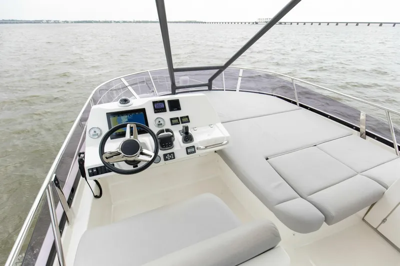 Pass-n-bye Yacht Photos Pics 2023 Prestige 460 Flybridge yacht helm with modern controls and spacious seating on open water.
