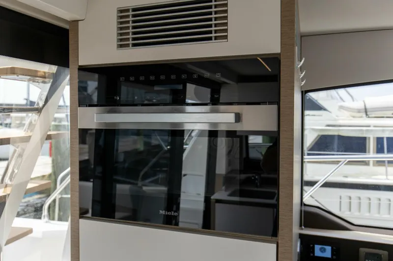 Pass-n-bye Yacht Photos Pics Modern kitchen appliance on 2023 Prestige 460 Flybridge yacht interior.