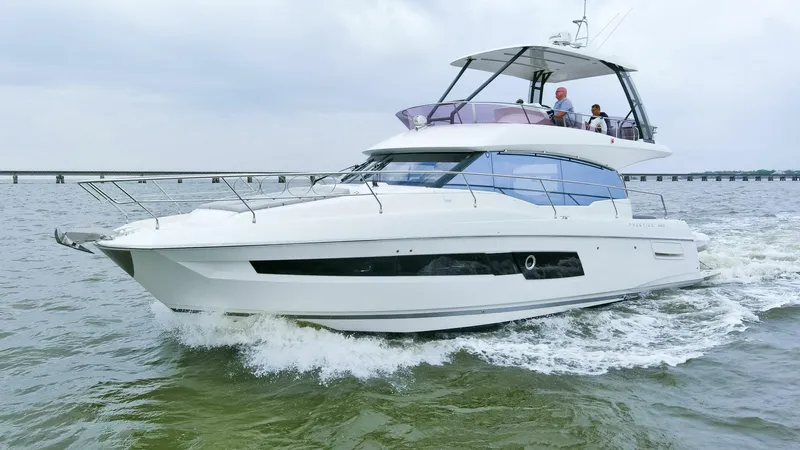 Pass-n-bye Yacht Photos Pics 2023 Prestige 460 Flybridge yacht cruising on open water, showcasing sleek design and luxury features.