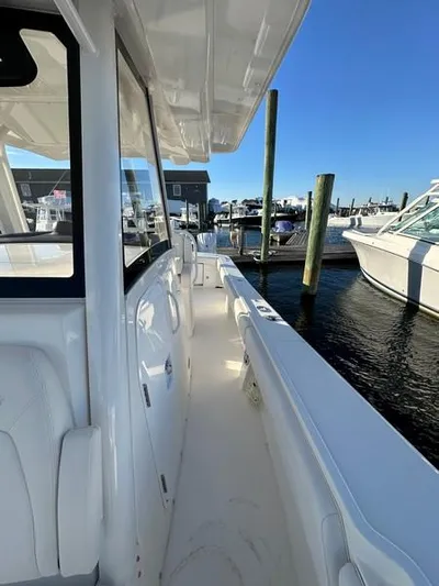 Cordon Bleu Yacht Photos Pics 2023 Regulator 34 boat docked at marina under clear blue sky.