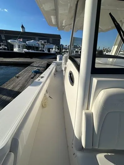 Cordon Bleu Yacht Photos Pics 2023 Regulator 34 boat docked at marina under clear blue sky.