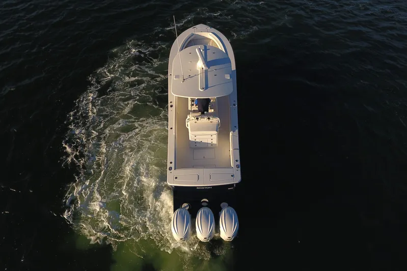 Cordon Bleu Yacht Photos Pics Aerial view of 2023 Regulator 34 boat with triple engines on open water.